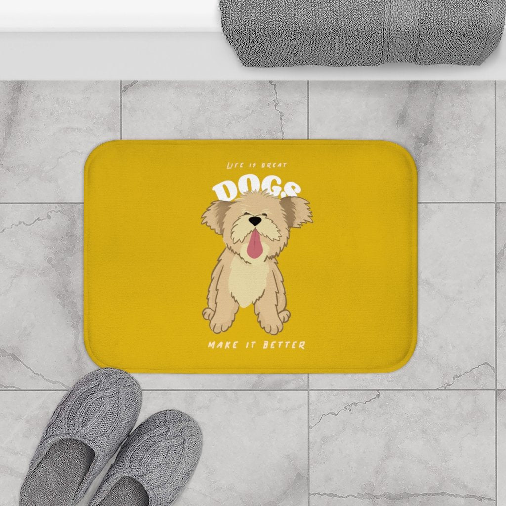 Yellow bath mat with a dog illustration and text on a tiled bathroom floor.