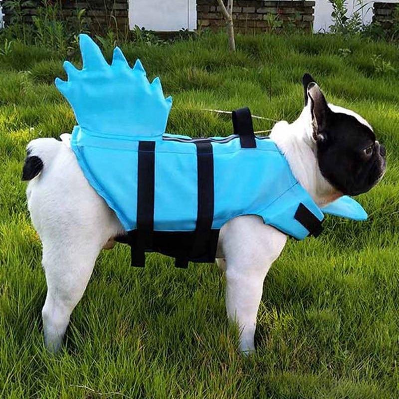 Blue shark-fin dog life vest with adjustable straps; all-season polyester dog swimwear.